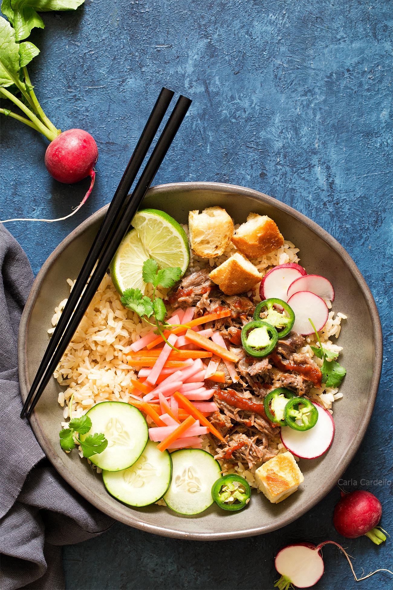Rice bowls topped with traditional Vietnamese ingredients.