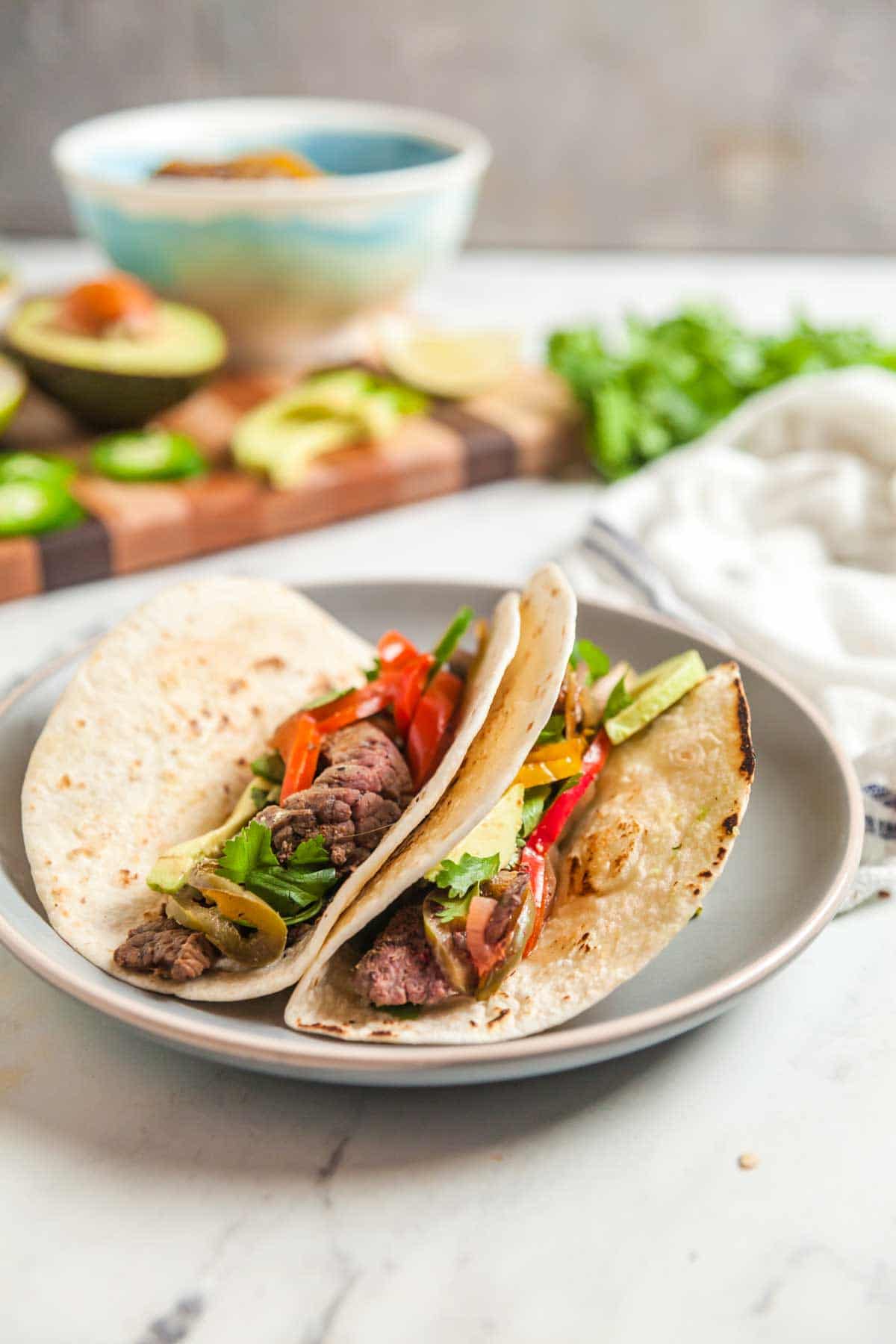 two steak fajitas on a plate